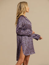 [Purple Leopard] Purple leopard-print shirt dress in a side view from head to knees, both hands held in front of the torso. 004